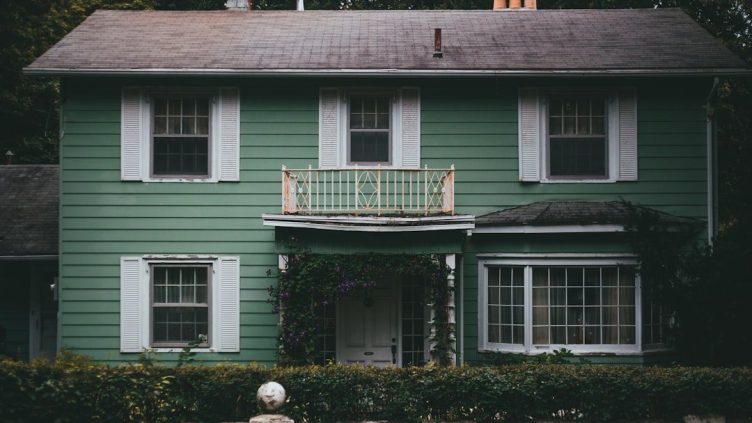 Homeowner creating home swap listing in living room